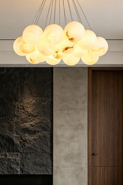 Amandine Alabaster Globe Cluster Pendant Light hanging in a modern dining room, featuring elegant alabaster globe design.