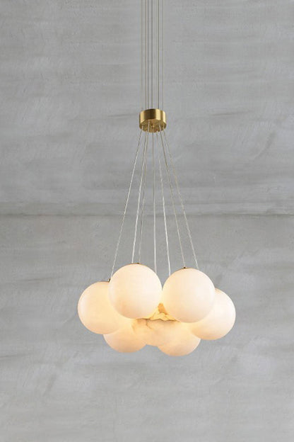 Amandine Alabaster Globe Cluster Pendant Light hanging above a gray background, showcasing its elegant alabaster globes.