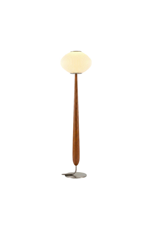 Arden Walnut Floor Lamp | Wood, Metal, Fabric | Isolated lit view of a mid-century modern floor lamp featuring a pleated white pumpkin saucer shade on a tapered teardrop-shaped natural walnut wood stem and a circular brushed silver base | White background | vexa lamps