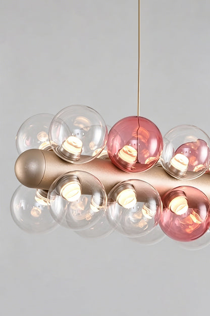 Astraea Linear Prismatic Globe Chandelier featuring hand-blown glass spheres and a brushed champagne-gold finish.