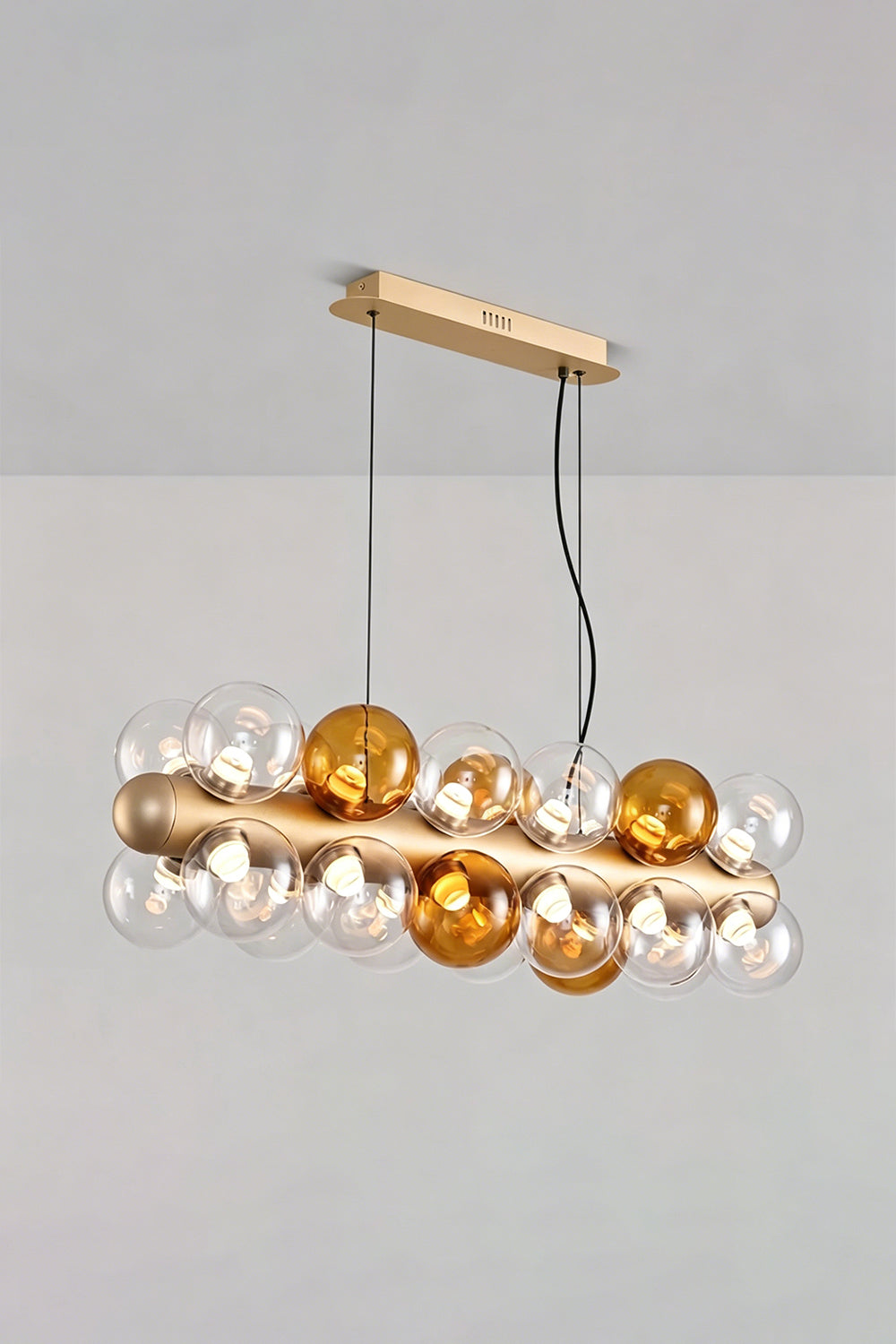 Astraea Linear Prismatic Globe Chandelier featuring hand-blown glass spheres in a brushed champagne-gold finish.
