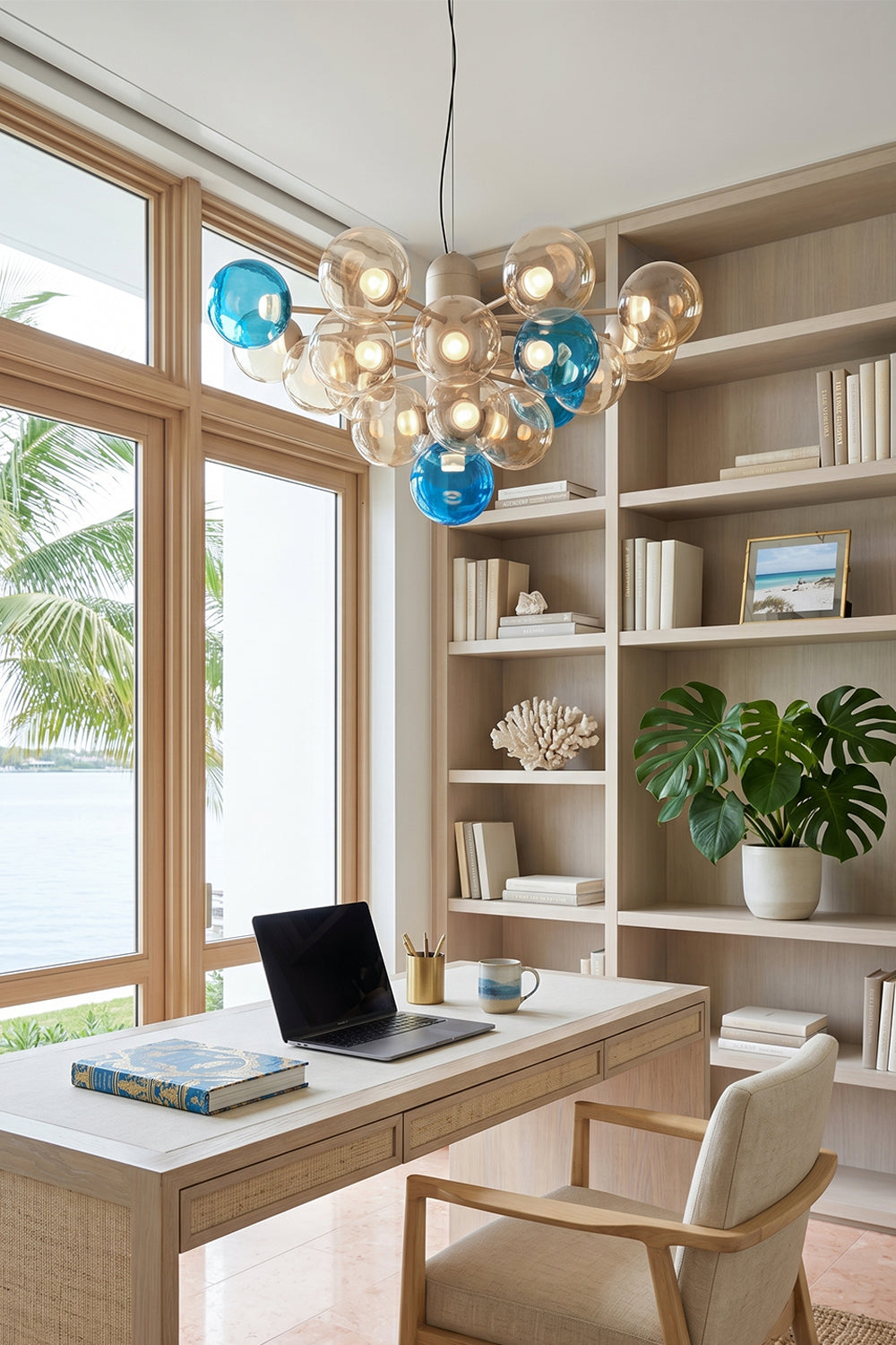 Astraea Prismatic Globe Chandelier | Glass, Metal | Placed as a statement light fixture in a modern home office with a minimalist desk and built-in library bookshelves | vexa lamps