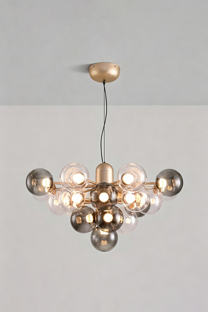Astraea Prismatic Globe Chandelier | Glass, Metal | Studio view of the smoky mirror grey glass bubble variant fully illuminated against a plain grey backdrop | vexa lamps