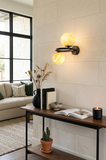 Aura Two-Globe Alabaster Wall Sconce illuminating a modern living space with elegant design and natural stone.