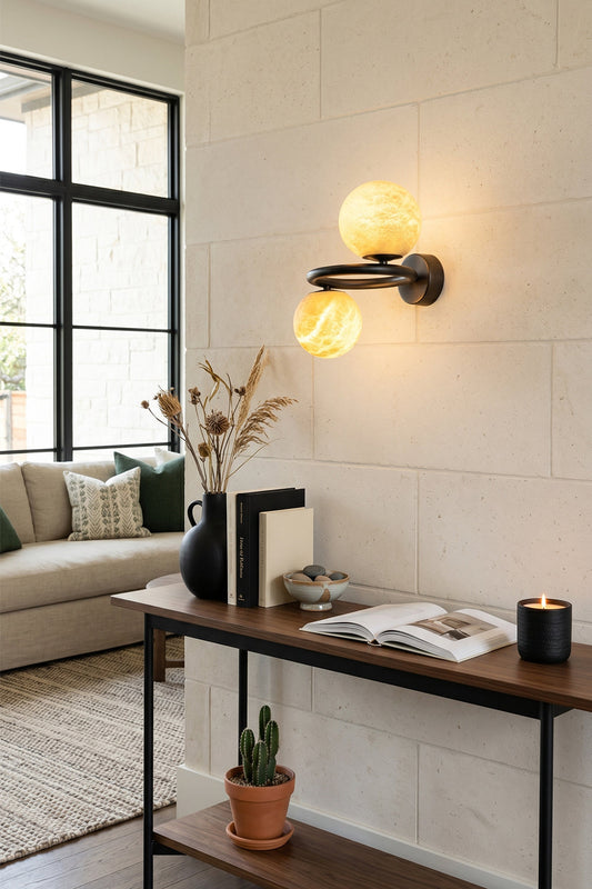 Aura Two-Globe Alabaster Wall Sconce illuminating a modern living space with elegant design and natural stone.
