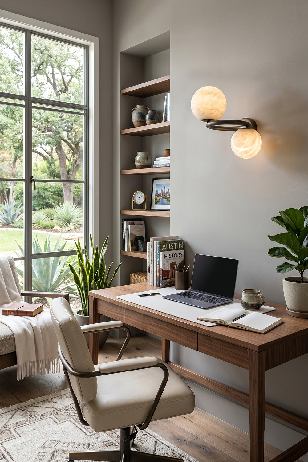 Aura Two-Globe Alabaster Wall Sconce illuminating a stylish home office with elegant decor.
