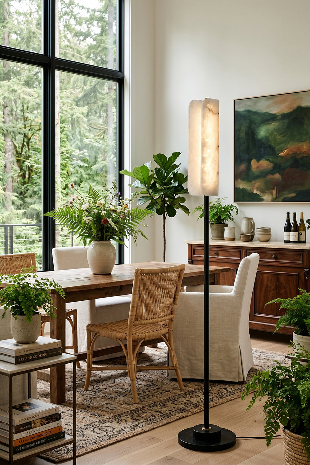 Aurelius Alabaster Brass Floor Lamp | Alabaster, Brass | Staged as an elegant corner light fixture in a bright formal dining room next to a wooden table and woven cane dining chairs | vexa lamps