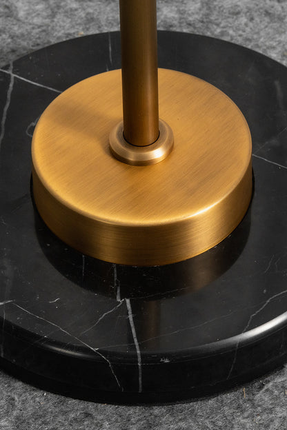 Aurelius Alabaster Brass Floor Lamp | Alabaster, Brass | Close-up structural view of the heavy circular brushed brass stem collar resting on the polished round black marble base plate with white veins | Detail shot | vexa lamps