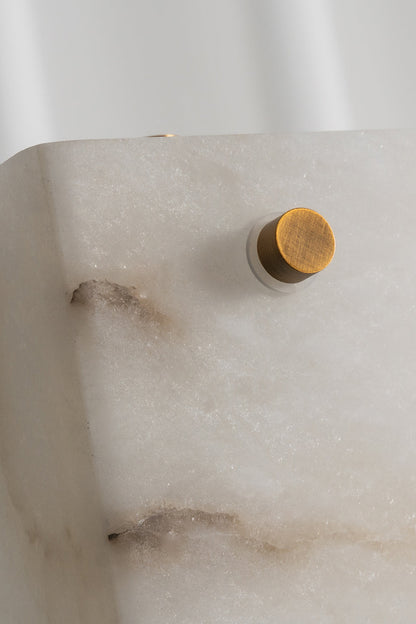 Aurelius Alabaster Brass Floor Lamp | Alabaster, Brass | Macro shot focusing on the external brushed gold brass screw bolt secured onto the natural white alabaster slab displaying rich brown veining | Detail shot | vexa lamps