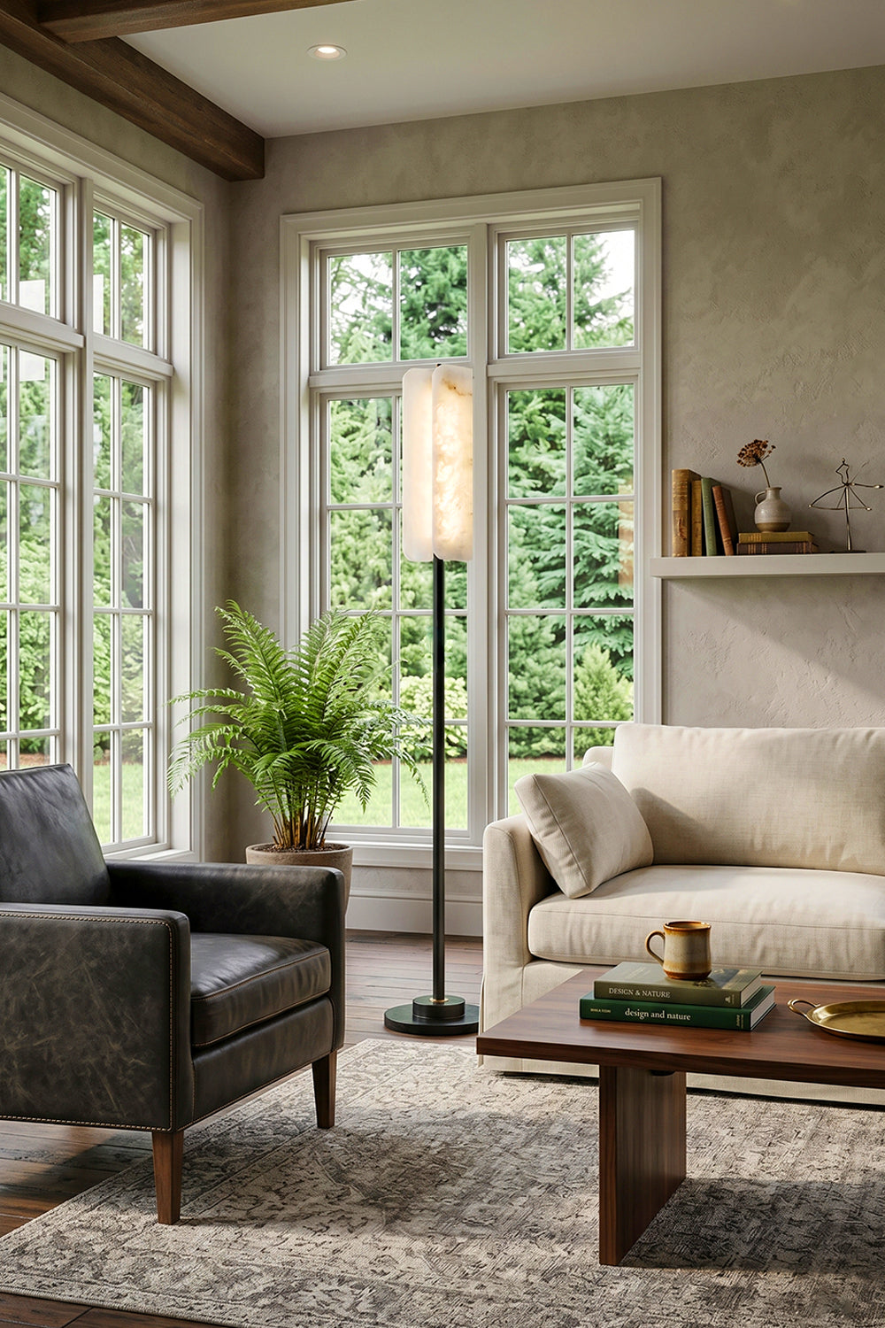 Aurelius Alabaster Brass Floor Lamp | Alabaster, Brass | Placed next to a dark grey upholstered armchair and a cream couch in a spacious sunlit lounge room near large grid windows | vexa lamps