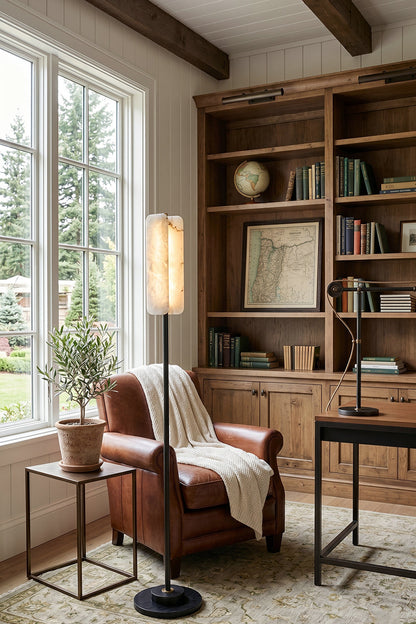 Aurelius Alabaster Brass Floor Lamp | Alabaster, Brass | Standing as an elegant reading light in a traditional study room next to a brown leather armchair and a large wooden bookcase | vexa lamps