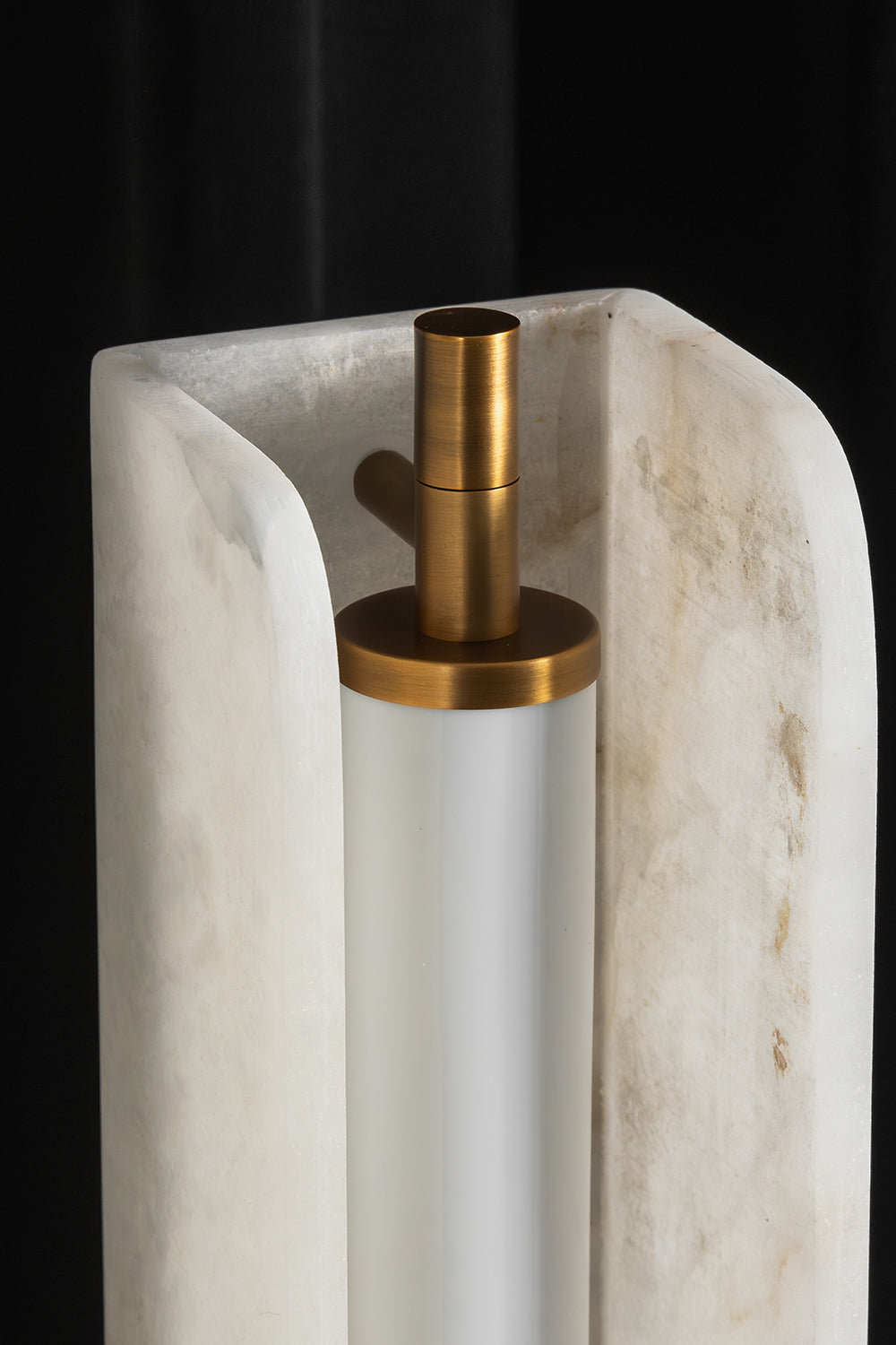 Aurelius Alabaster Brass Floor Lamp | Alabaster, Brass | Close-up top structural shot highlighting the inner frosted glass diffuser tube and brushed brass cap inside the translucent U-shaped alabaster block | Detail shot | vexa lamps