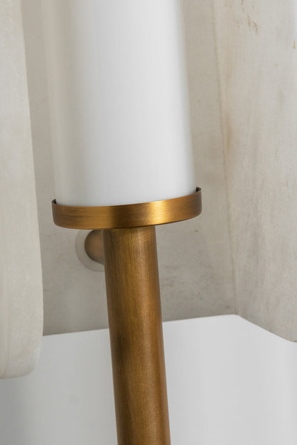 Aurelius Alabaster Brass Floor Lamp | Alabaster, Brass | Detailed shot showing the connection point where the slim vertical gold brass rod meets the base of the cylindrical white light diffuser | Detail shot | vexa lamps