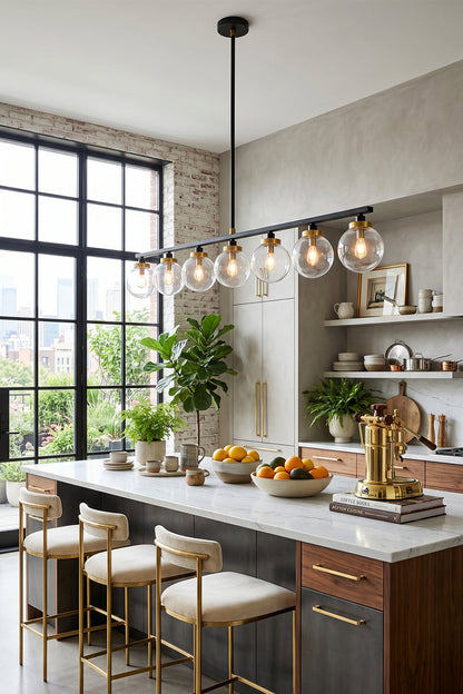 Brooks Linear Glass Globe Chandelier | Glass, Metal | Hanging as stylish island lighting in a modern industrial kitchen, casting a warm glow over wooden barstools and a marble countertop | vexa lamps