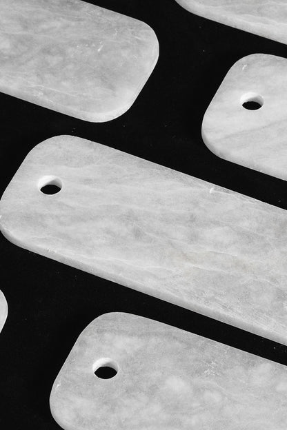 Callista Tiered Alabaster Chandelier | Alabaster, Metal | Macro close-up view of loose rectangular white alabaster stone plates showcasing their pre-drilled holes and natural mineral cloud patterns | Detail shot | vexa lamps