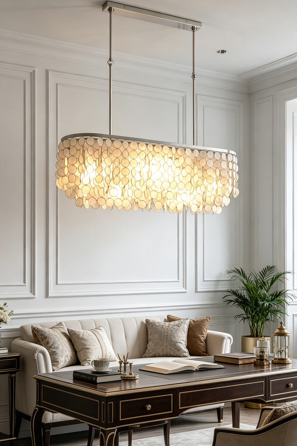 Luxury elongated shell chandelier | Iron | Shell | Hanging in a sophisticated living room over a dark coffee table | vexa lamps