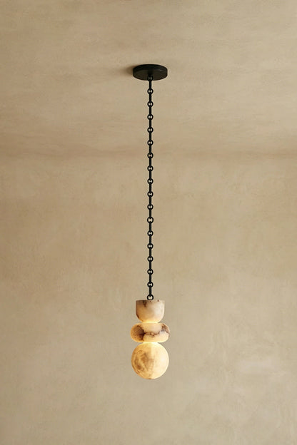 Single Alabaster Pendant | Alabaster, Metal | Straight vertical hanging against neutral wall | vexa lamps