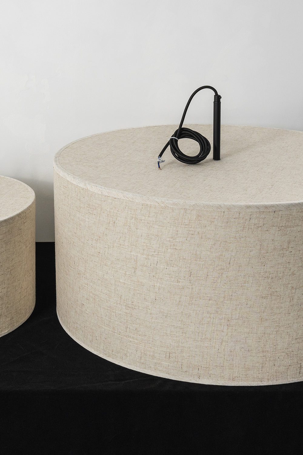 Concentric Veil Detail | Fabric, Metal | Top-down view of black cord and shade connection on a white surface | vexa lamps
