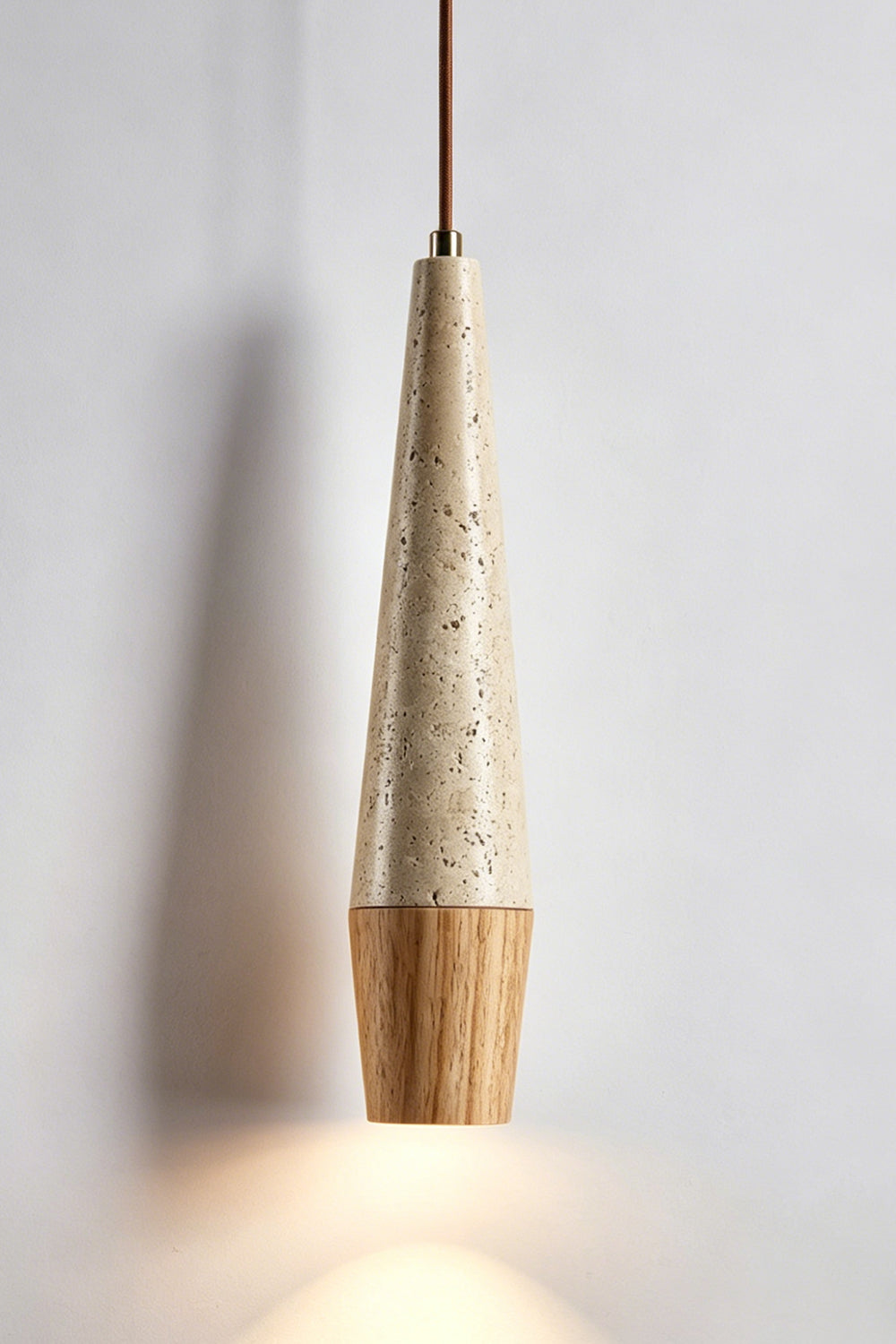 Conical Tiber Travertine Pendant Light | Travertine, Wood | Light wood base detail, lit product shot | vexa lamps