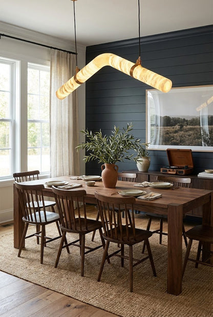 Linear undulating alabaster chandelier | Alabaster, Brass | Mounted in a bright wooden dining area with natural light | vexa lamps