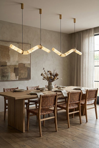Contemporary alabaster pendant over a set dining table | Alabaster, Brass | Interior scene with neutral walls and classic decor | vexa lamps