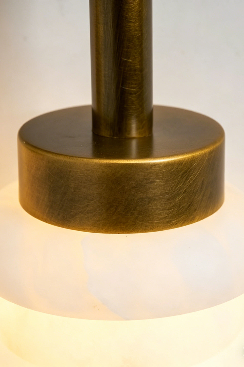 Dual Strata Alabaster Wall Lamp | Metal, Alabaster | Perspective view of lit lamp against a light grey background | vexa lamps