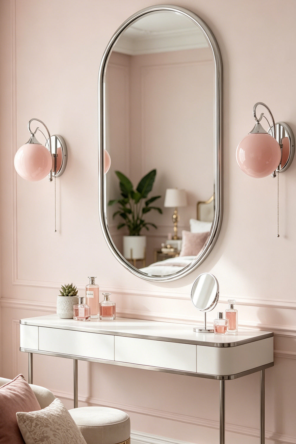 Pair of pink glass globe sconces | Metal, Glass | Vanity flanking oval mirror in soft pink room | vexa lamps