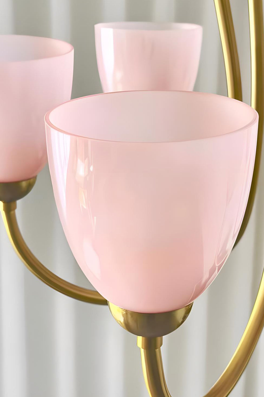 Close-up of illuminated pink glass shades on a Ethereal Floret Chandelier | Metal, Glass | Detail shot of lit shades on metal arms | vexa lamps