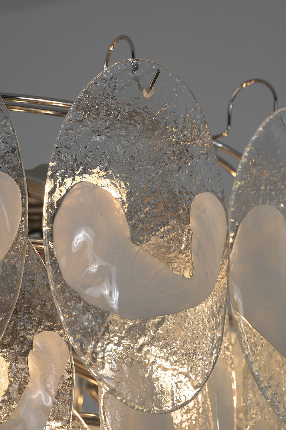 Close-up of lit glass leaves on the Frostelle chandelier | Glass | Detail shot showing light through textured glass | vexa lamps