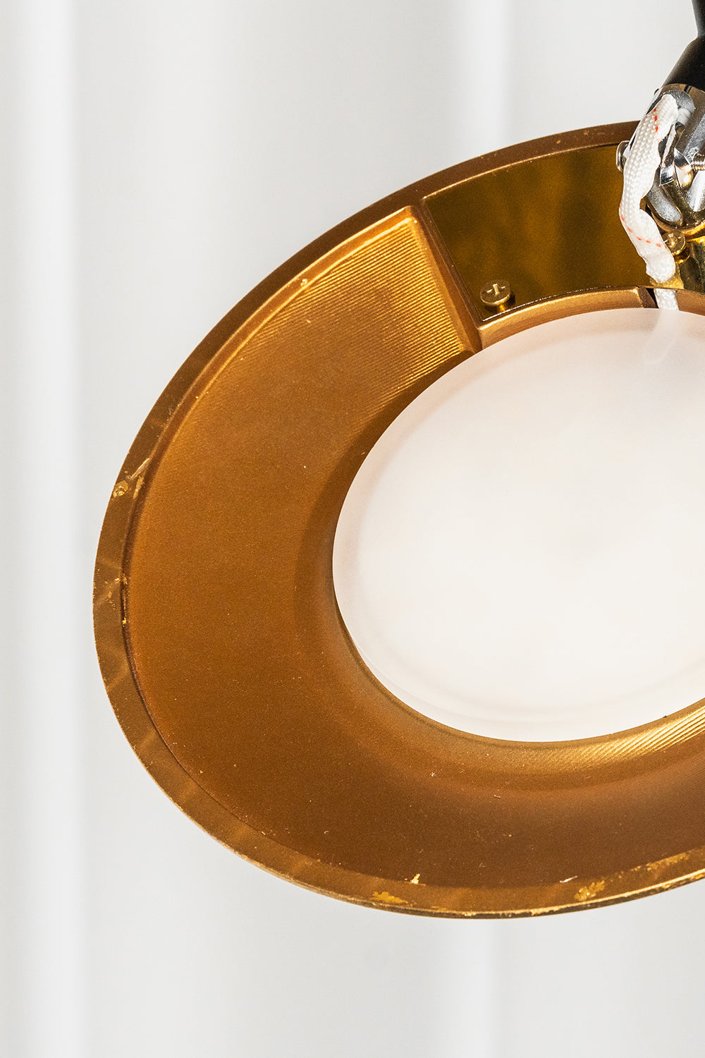 Gold-Tone Sculptural Ceiling Light showcasing a textured gold canopy with a white light fixture.