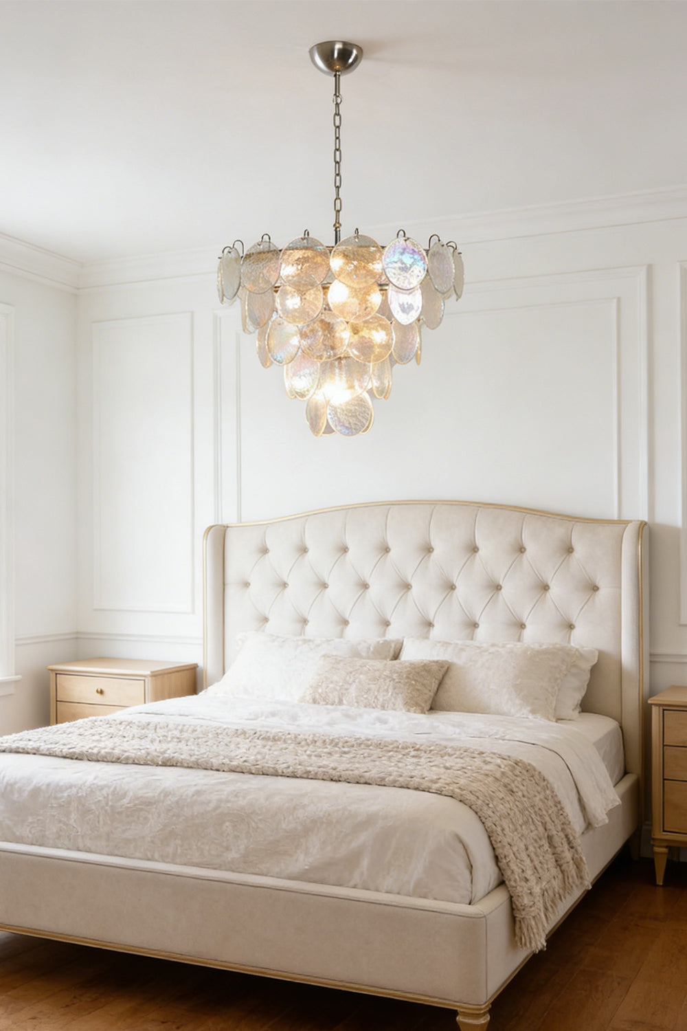Serene iridescent glass chandelier | Metal, Glass | Mounted in a master bedroom above a tufted bed | vexa lamps