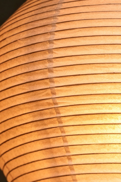 Isolde Stacked Paper Pendant Lamp | Textured Ribbed Paper | Macro close-up shot detailing the intricate ribbed texture of the warm glowing paper shade | vexa lamps