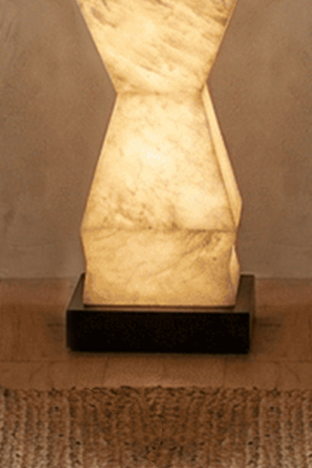 Kellan Geometric Alabaster Floor Lamp | Alabaster, Metal | Detailed close-up showing the sturdy flat square dark base plate supporting the lowest angular alabaster stone segment | Detail shot | vexa lamps