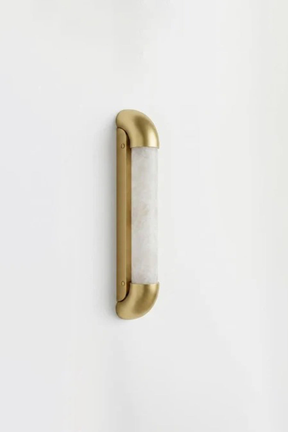 Kester Alabaster Tube Wall Sconce featuring natural alabaster and curved metal frame against a white wall.
