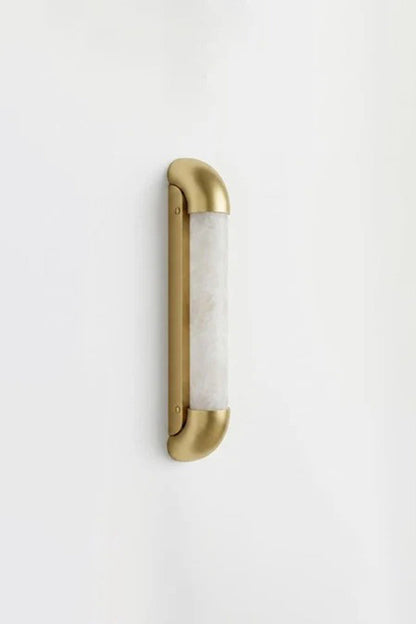 Kester Alabaster Tube Wall Sconce featuring natural alabaster and curved metal frame against a white wall.