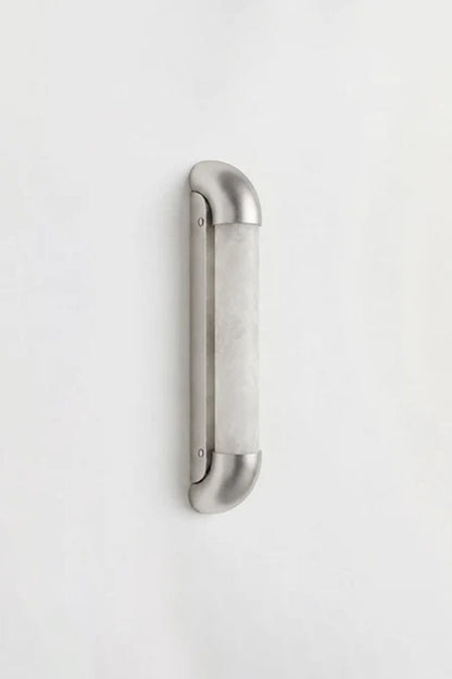 Kester Alabaster Tube Wall Sconce with a sleek curved metal frame and natural alabaster shade