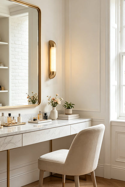 Kester Alabaster Tube Wall Sconce illuminating a stylish vanity area with a soft glow and elegant decor.