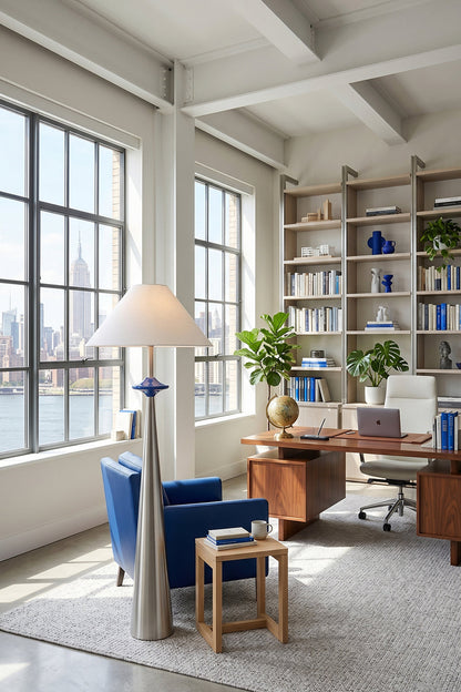 Lazuro Postmodern Cone Floor Light | Metal, Fabric | Placed in a sunlit industrial loft office corner next to a blue accent armchair and a large wooden executive desk | vexa lamps