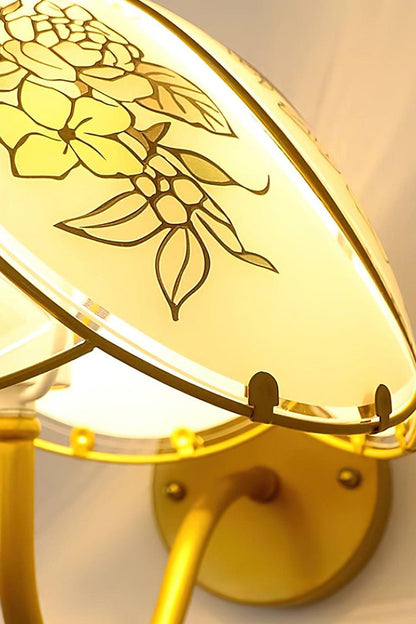 Lillian Retro Floral Wall Lamp | Glass, Metal | Upward close-up perspective of the lit floral glass panel and its decorative golden metal frame | Detail shot | vexa lamps
