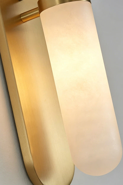 Linea Alabaster Capsule Wall Sconce | Alabaster, Brass | Close-up shot of the illuminated capsule wall fixture showcasing the translucent crystalline texture of natural alabaster | Detail shot | vexa lamps