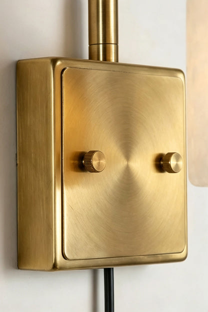 Liora Scalloped Alabaster Wall Sconce | Natural Alabaster and Brushed Brass | Detailed close-up view highlighting the smooth texture and screws of the rectangular brass mounting plate | vexa lamps