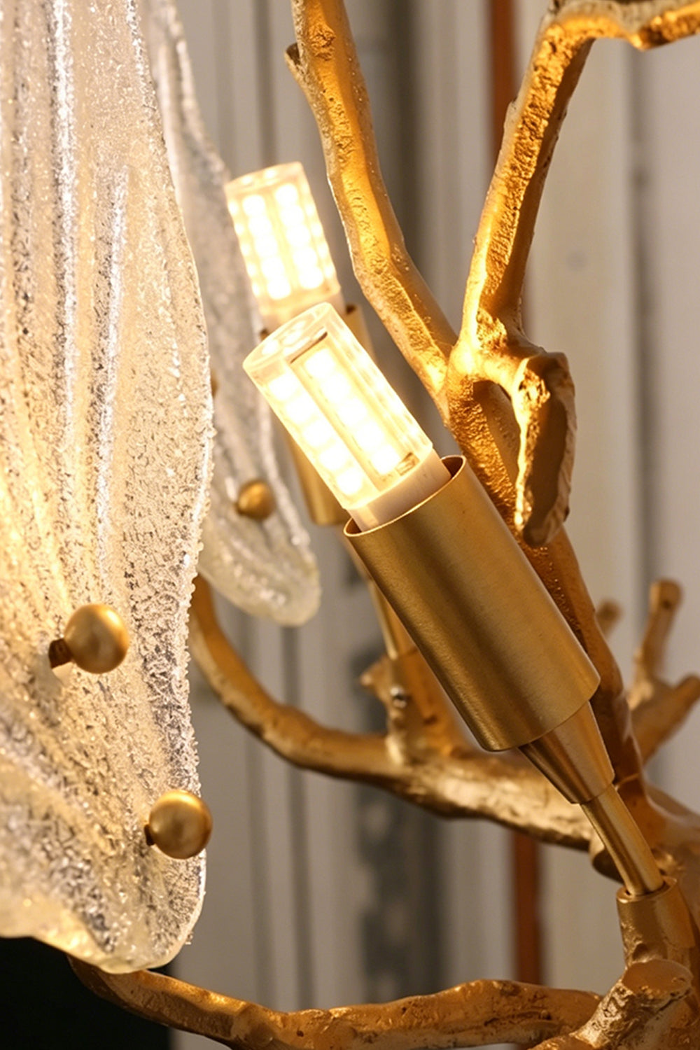 Magnolia Arbor Brass Wall Lamp | Brass, Glass | Detailed view revealing the internal gold cylindrical bulb sockets behind the textured glass elements | Detail shot | vexa lamps
