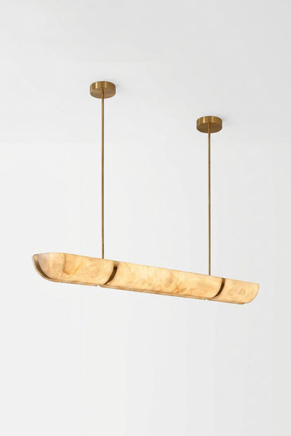 Marlen Alabaster Bar Linear Pendant Light hanging in a modern setting with gold accents.