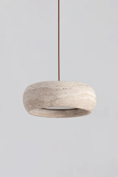 Maro Travertine Donut Pendant Light | Travertine, Metal | Studio front profile view of the unlit organic beige stone donut hanging lamp displayed against a plain grey backdrop | vexa lamps