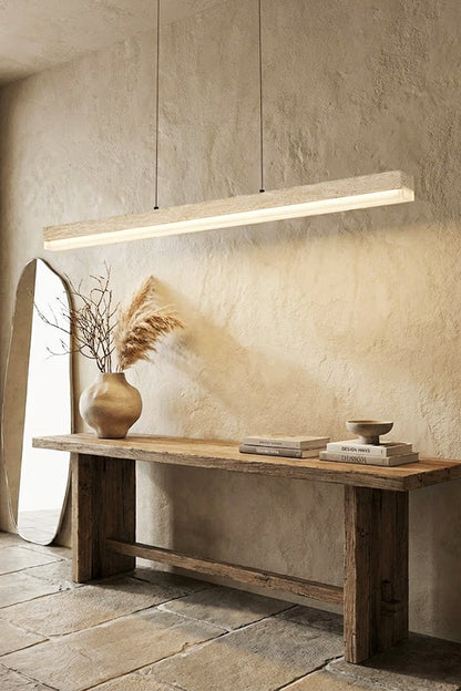 Natural travertine linear lamp against a stone wall | Travertine, Wood, Acrylic | Over a rustic wooden console table | vexa lamps
