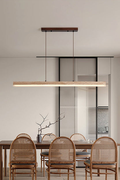 Linear travertine dining light over rattan chairs | Travertine, Wood, Acrylic | Interior scene in a warm contemporary dining room | vexa lamps