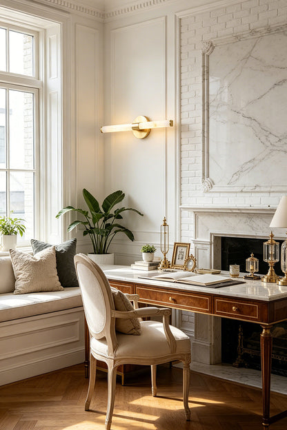 Nerida Linear Alabaster Wall Sconce | Alabaster, Brass | Providing sophisticated ambient lighting on a paneled wall in a traditional home study next to a window bench and stone fireplace | vexa lamps