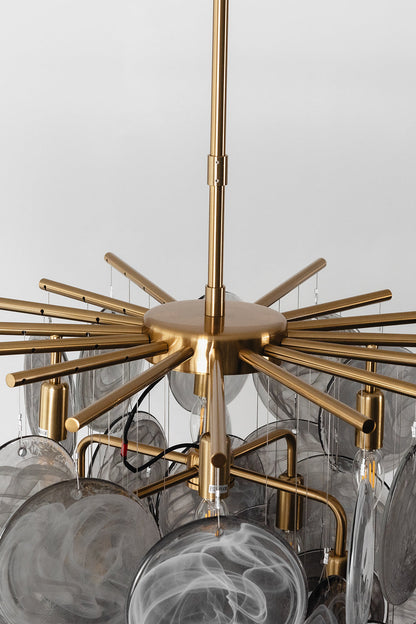 Nimbus Smoked Glass Disc Chandelier showcasing hand-blown glass discs in an elegant design with a gold framework.
