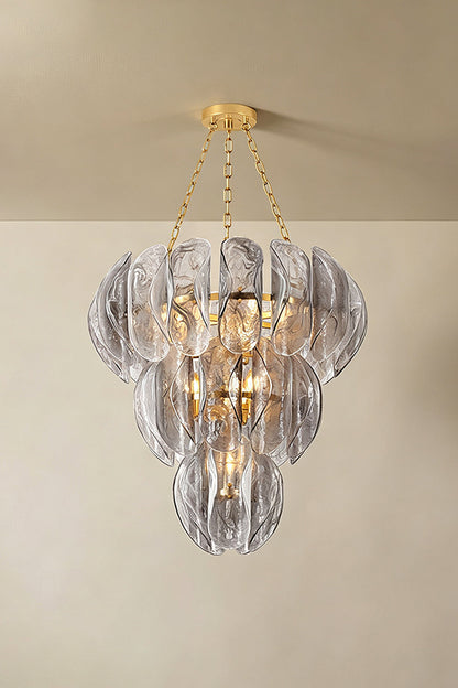 Ondine Cascading Leaf Glass Chandelier | Textured Smoked Glass and Gold Metal | Displayed hanging from a plain plaster ceiling casting soft warm ambient illumination in a room | vexa lamps