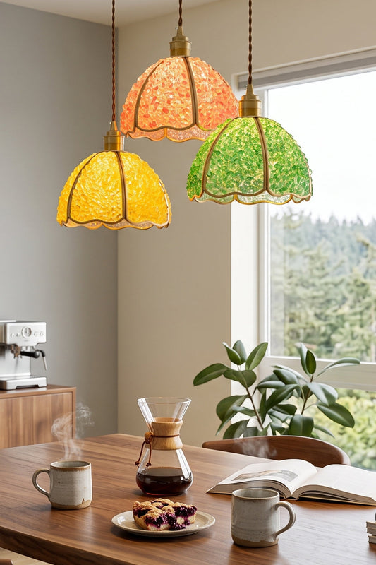 Ondine Mosaic Glass Pendant Light hanging above a kitchen table with coffee and snacks, showcasing vibrant yellow and green color.